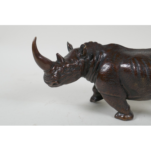 93 - A filled bronze rhinoceros, 23cm long