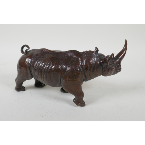 93 - A filled bronze rhinoceros, 23cm long