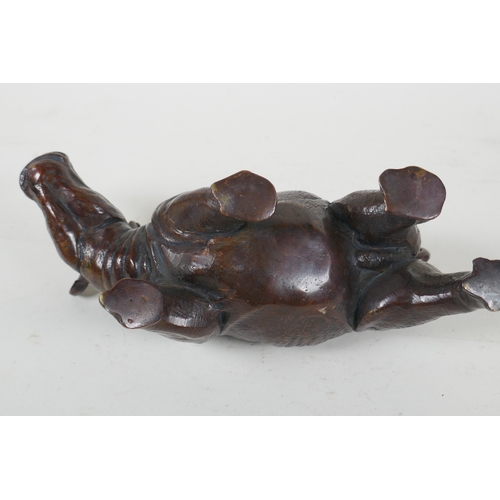 93 - A filled bronze rhinoceros, 23cm long