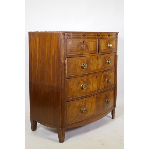 1148 - A Regency mahogany bowfront chest, with inlaid frieze and two over three drawers, flanked by reeded ... 