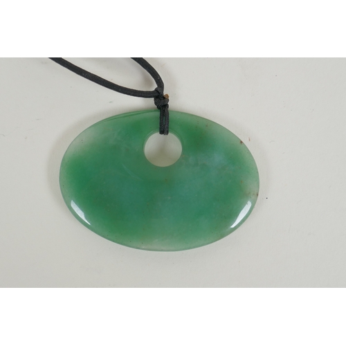 671 - A Nephrite jade pendant necklace, 7 x 5cm