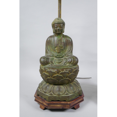 10 - A pair of Chinese bronze Buddha table lamps, with ver de gris patina and wood bases, 62cm high