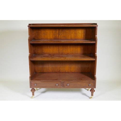 1069 - A Regency style mahogany waterfall bookcase with two drawers, raised on turned supports, 96 x 34 x 1... 