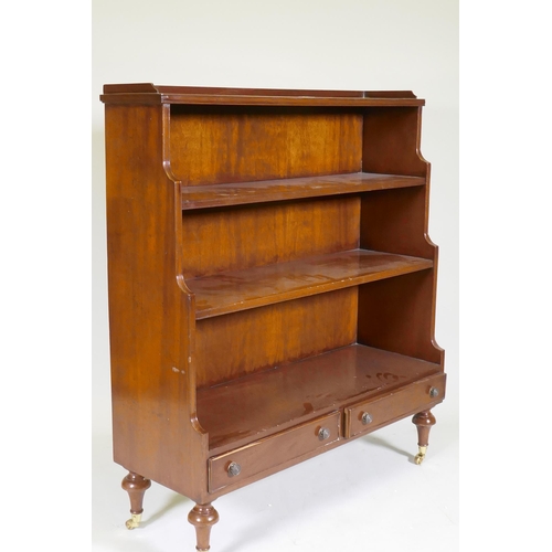 1069 - A Regency style mahogany waterfall bookcase with two drawers, raised on turned supports, 96 x 34 x 1... 