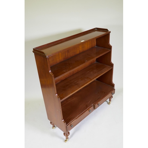 1069 - A Regency style mahogany waterfall bookcase with two drawers, raised on turned supports, 96 x 34 x 1... 