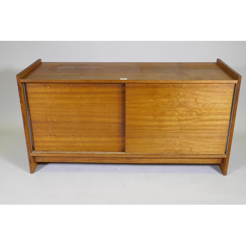 1071 - A mid century rosewood side cabinet with two slide doors, 125 x 46 x 65cm