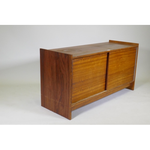 1071 - A mid century rosewood side cabinet with two slide doors, 125 x 46 x 65cm