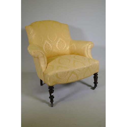 1073 - A C19th bow back arm chair with shaped front, raised on turned supports with brass castors