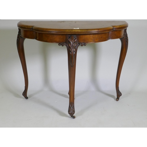 1075 - Victorian inlaid burr walnut shaped top card table, fitted with drawer to back, raised on carved cab... 