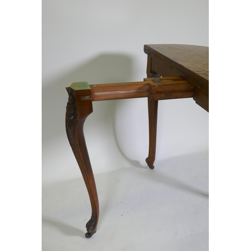 1075 - Victorian inlaid burr walnut shaped top card table, fitted with drawer to back, raised on carved cab... 