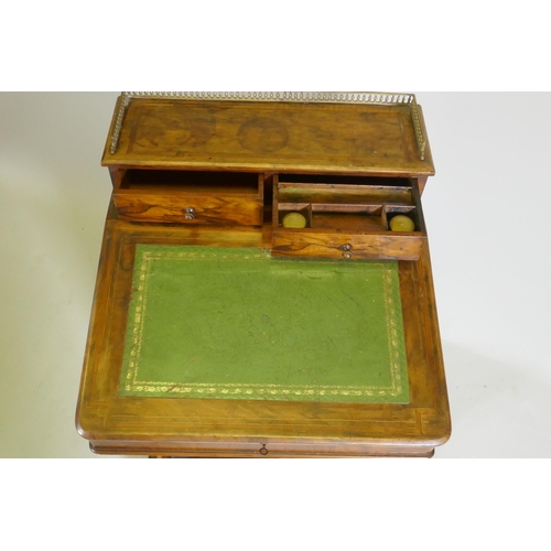 1077 - A Victorian inlaid figured walnut davenport, with pierced gallery over two drawers, one fitted with ... 