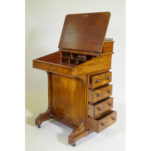 1077 - A Victorian inlaid figured walnut davenport, with pierced gallery over two drawers, one fitted with ... 