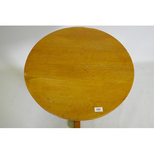 1082 - An early / mid century golden oak occasional table, stamped AM, Air Ministry, 61cm diameter, 65cm hi... 