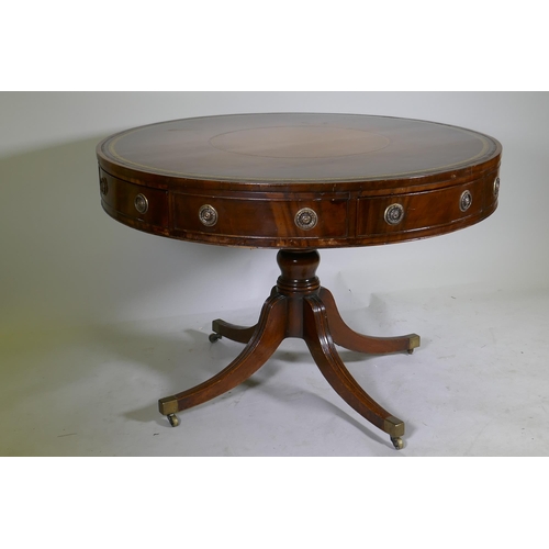 1083 - A C19th mahogany drum table, with inset gilt tooled leather top, four true and four false drawers, r... 