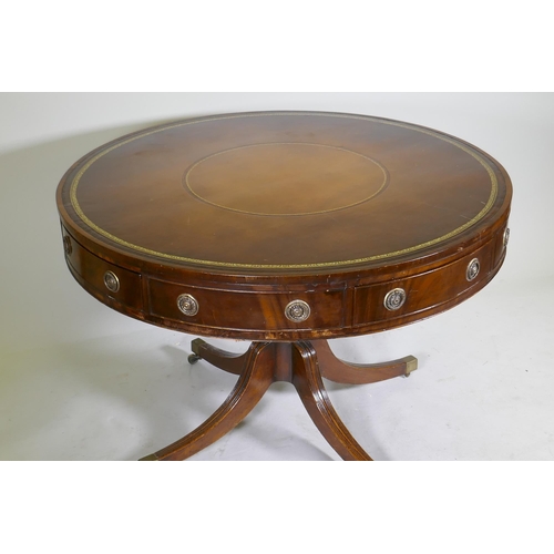 1083 - A C19th mahogany drum table, with inset gilt tooled leather top, four true and four false drawers, r... 