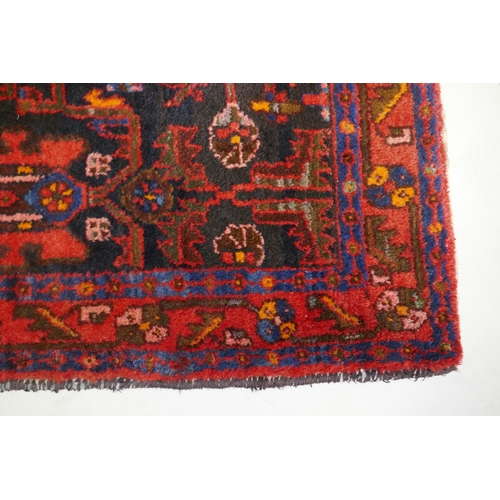 1087 - A Persian Hamadan red ground wool rug with unique geometric design, 148 x 104cm