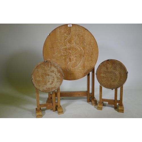 1090 - A set of three Art Deco limed oak occasional tables with carved Chinese dragon decoration, largest 6... 