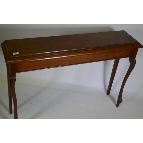 1091 - A mahogany hall table, raised on carved shaped supports, 112 x 27 x 77cm