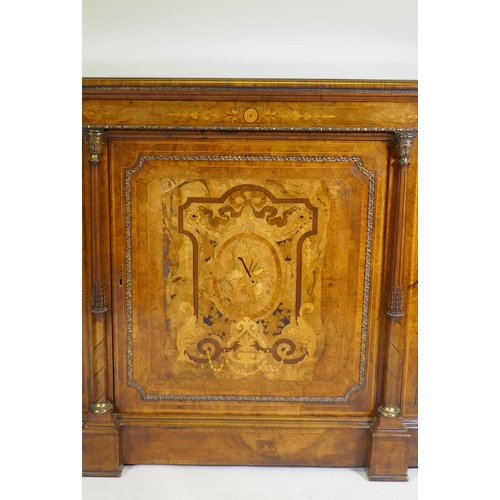 1096 - A Victorian inlaid burr walnut credenza with brass mounts, two bow end glazed doors and central marq... 