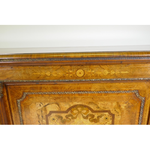 1096 - A Victorian inlaid burr walnut credenza with brass mounts, two bow end glazed doors and central marq... 