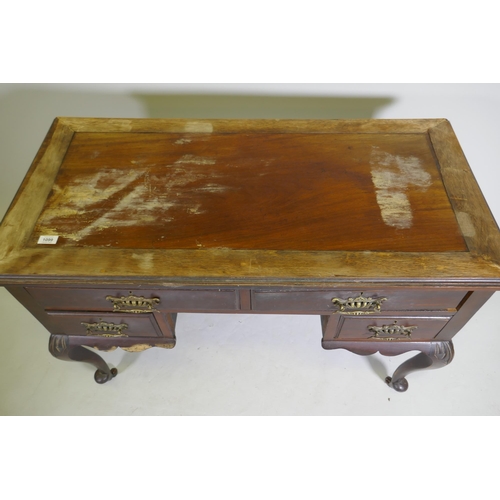 1099 - A Victorian mahogany four drawer kneehole desk, raised on carved cabriole supports, 110 x 52 x 76cm