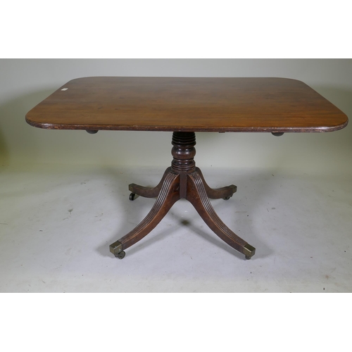 1100 - A Regency mahogany tilt top breakfast table, with single piece top and reeded edge, raised on turned... 