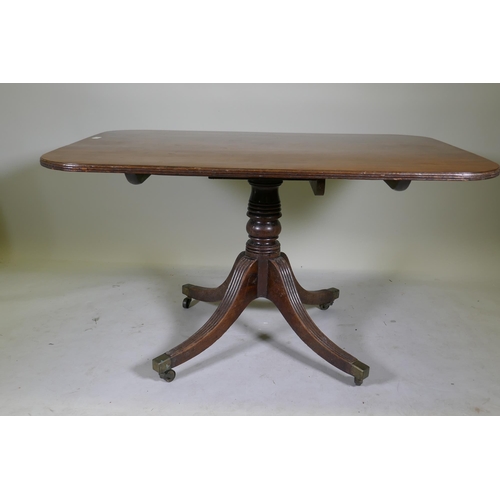 1100 - A Regency mahogany tilt top breakfast table, with single piece top and reeded edge, raised on turned... 