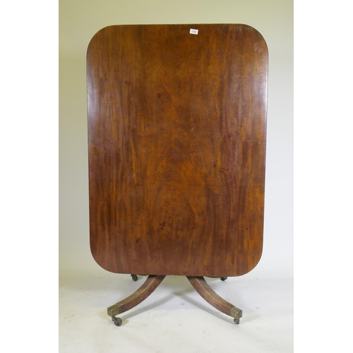 1100 - A Regency mahogany tilt top breakfast table, with single piece top and reeded edge, raised on turned... 