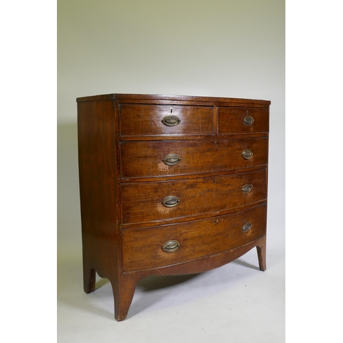 1103 - A George II mahogany bow front chest of two over three drawers, with brass plate handles, raised on ... 