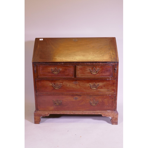 1105 - A George III mahogany fall front bureau, the interior with pigeon holes and drawers and secret drawe... 