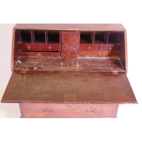 1105 - A George III mahogany fall front bureau, the interior with pigeon holes and drawers and secret drawe... 