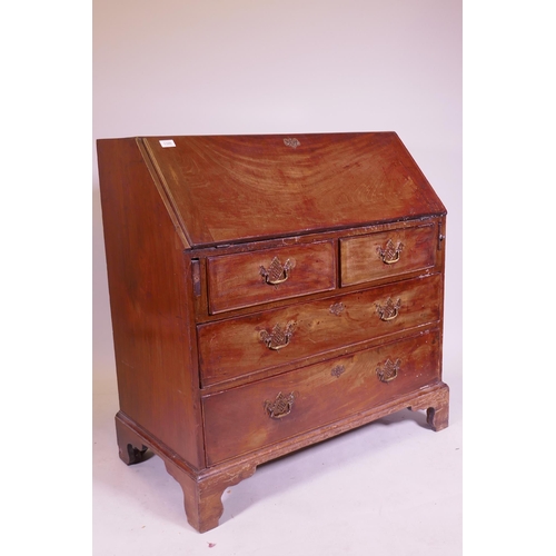 1105 - A George III mahogany fall front bureau, the interior with pigeon holes and drawers and secret drawe... 