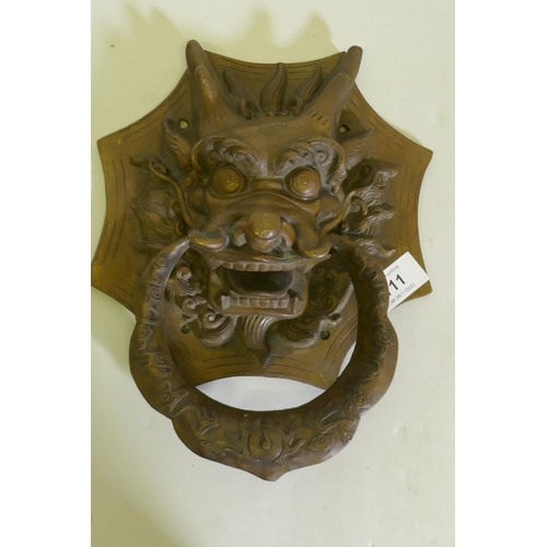 111 - A Chinese bronze dragon's mask door knocker, 27cm high