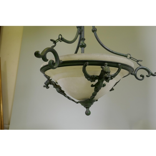 1111 - A pair of bronzed metal ceiling lamps with winged dragon decoration and etched glass shades, 65cm di... 