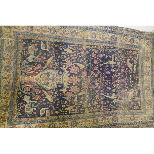 1112 - An oriental hand woven wool carpet, with vase and bird decoration, worn, 126 x 194cm