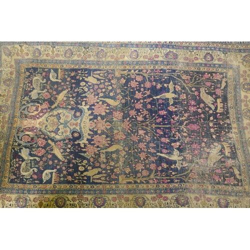 1112 - An oriental hand woven wool carpet, with vase and bird decoration, worn, 126 x 194cm