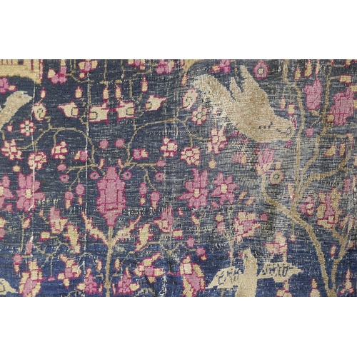 1112 - An oriental hand woven wool carpet, with vase and bird decoration, worn, 126 x 194cm