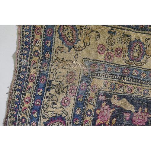 1112 - An oriental hand woven wool carpet, with vase and bird decoration, worn, 126 x 194cm