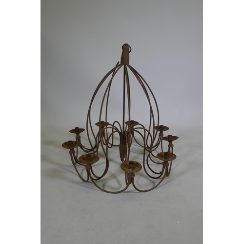 1117 - A wrought iron 9 branch candle chandelier, 75cm drop