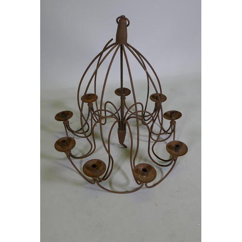 1117 - A wrought iron 9 branch candle chandelier, 75cm drop