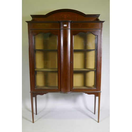 1119 - An Edwardian mahogany display cabinet with painted decoration and two doors raised on tapering suppo... 