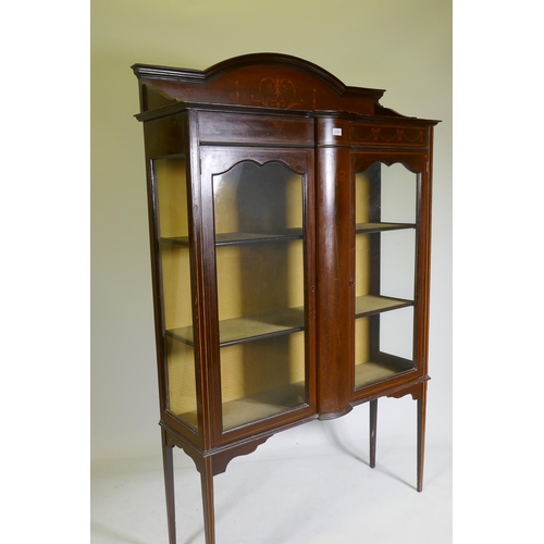 1119 - An Edwardian mahogany display cabinet with painted decoration and two doors raised on tapering suppo... 