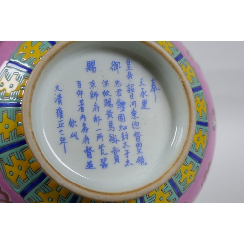 112 - A Chinese polychrome porcelain rice bowl, decorated with temple lions on a pink field, inscription t... 