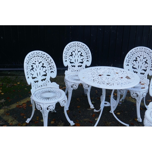 1123 - A painted aluminium Coalbrookdale style garden table and four chairs