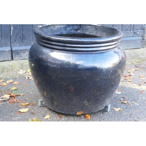 1124 - A pair of large black glazed ceramic garden pots, 59cm high, 70cm wide