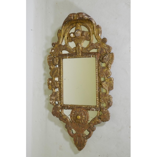 1140 - A C19th Italian gilt composition wall mirror with vine decoration, 92 x 48cm