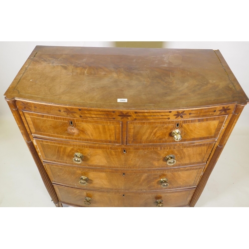 1148 - A Regency mahogany bowfront chest, with inlaid frieze and two over three drawers, flanked by reeded ... 