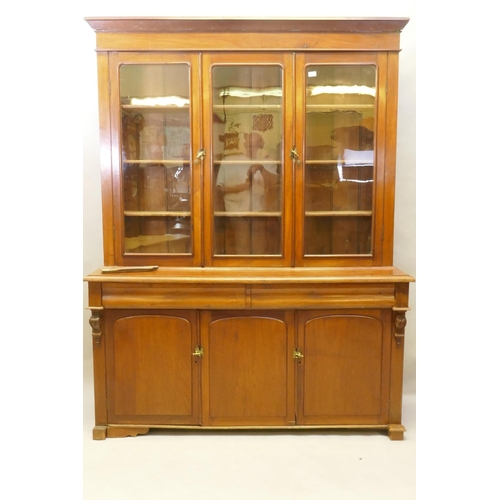 1150 - A C19th French stained fruitwood and walnut bookcase, the upper section with two glazed doors, fitte... 