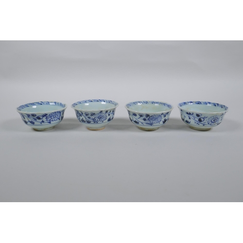 116 - Four Chinese Ming style blue and white porcelain tea bowls decorated with flowers, carp, figures and... 