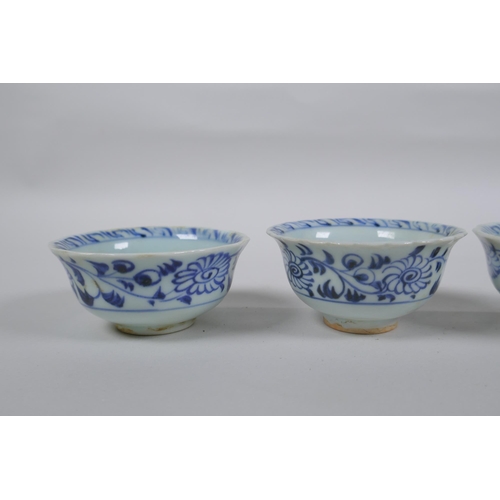 116 - Four Chinese Ming style blue and white porcelain tea bowls decorated with flowers, carp, figures and... 